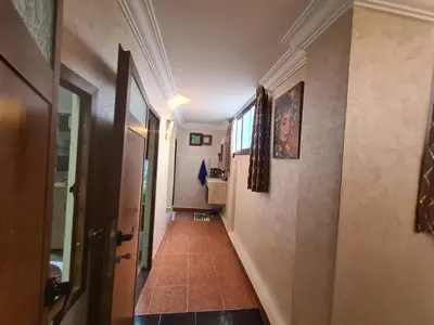 a hallway with a hallway leading to a room at House Silya in Oulad Akkou