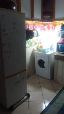 a kitchen with a refrigerator and a washing machine at Appartement à Agadir in Azrou