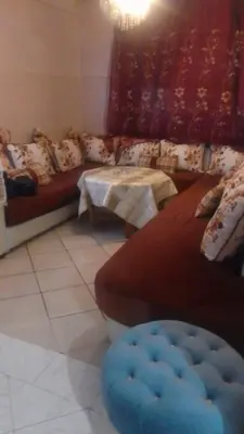 a living room with a couch and a table at Appartement à Agadir in Azrou