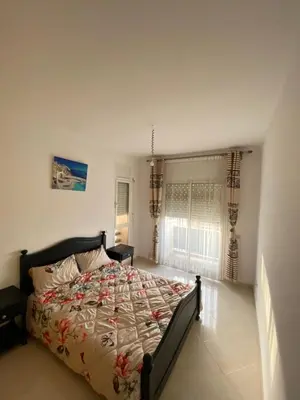 a bedroom with a large bed in a room at Facing the sea, close to the Corniche in Oulad Akkou