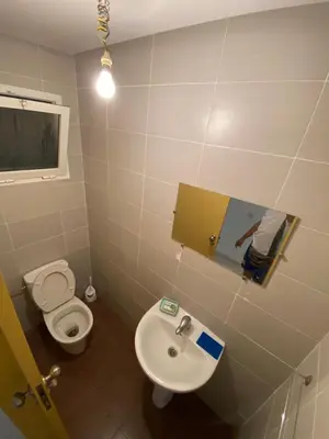 a bathroom with a toilet and a sink at Facing the sea, close to the Corniche in Oulad Akkou
