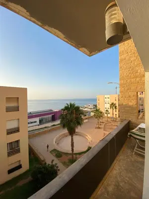 a view from the balcony of a building at Facing the sea, close to the Corniche in Oulad Akkou