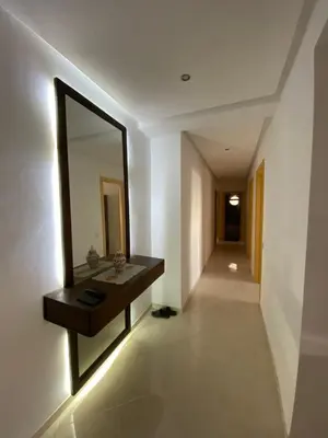a bathroom with a vanity and a mirror on the wall at Facing the sea, close to the Corniche in Oulad Akkou