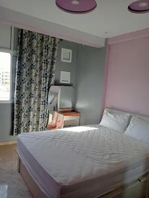 a bedroom with a bed and a window at Kinan in Fès