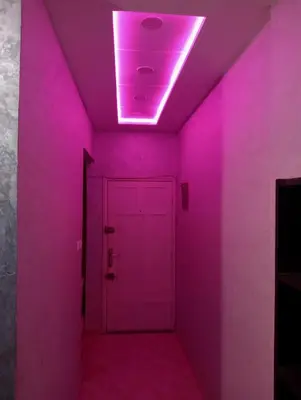 a purple hallway with a door and a light at Kinan in Fès