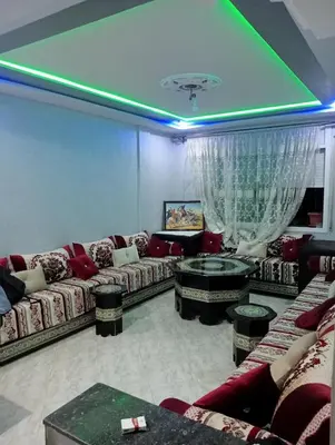 a living room with couches and a green ceiling at Kinan in Fès
