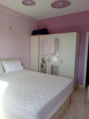 a bedroom with a white bed and purple walls at Kinan in Fès