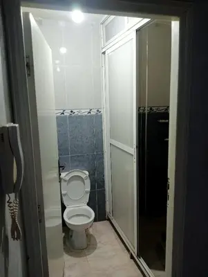 a bathroom with a toilet and a walk in shower at Kinan in Fès