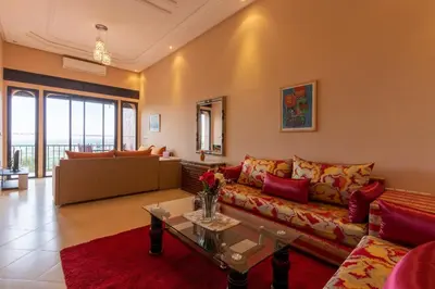 a living room with a couch and a table at Marrakech Le Joyau de l'ourika in Ourika