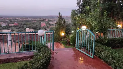 a gate to a garden with a view at Marrakech Le Joyau de l'ourika in Ourika