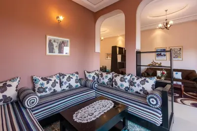 a living room with two couches and a table at Marrakech Le Joyau de l'ourika in Ourika