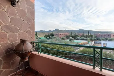 a balcony with a view of a mountain view at Marrakech Le Joyau de l'ourika in Ourika