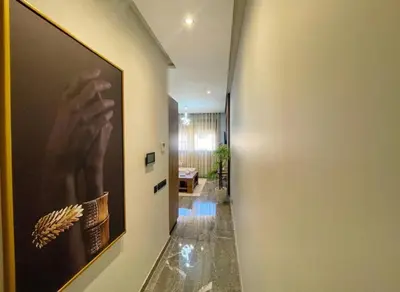 a hallway with a painting of a hand on the wall at Luxury Modern Studio with Netflix, Kitchen and Free Parking Elite Garden, Marrakesh in Aït Saïd