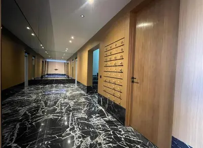 a hallway with a marble floor in a building at Luxury Modern Studio with Netflix, Kitchen and Free Parking Elite Garden, Marrakesh in Aït Saïd