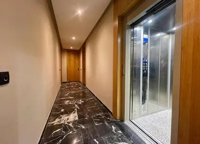 a hallway with a marble floor and a glass door at Luxury Modern Studio with Netflix, Kitchen and Free Parking Elite Garden, Marrakesh in Aït Saïd
