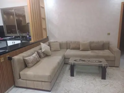 a living room with a couch and a coffee table at JOLIE APPART à BOUZNIKA in Oulad Akkou