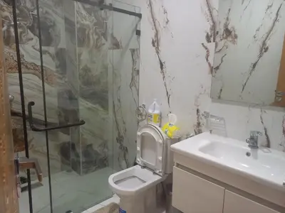 a bathroom with a shower and a toilet and a sink at JOLIE APPART à BOUZNIKA in Oulad Akkou