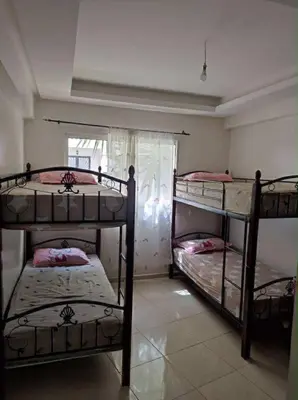 a bedroom with three bunk beds in a room at Appartement de vacances in Oulad Akkou