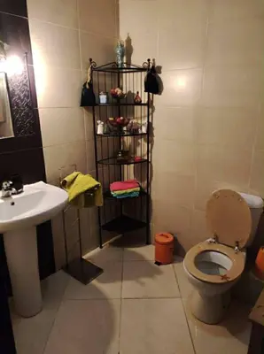 a bathroom with a toilet and a sink at Appartement de vacances in Oulad Akkou