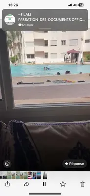 a view of a pool from the window of a bus at Appartement de vacances in Oulad Akkou