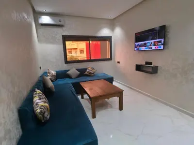 a living room with a blue couch and a table at appartement luxueux khenifra 1 in Khenifra