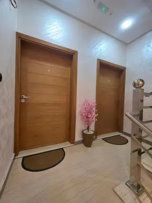 two wooden doors in a room with a potted plant at appartement luxueux khenifra 1 in Khenifra