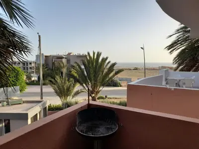 a black chair sitting on top of a building at Village al baraka in Oulad Akkou