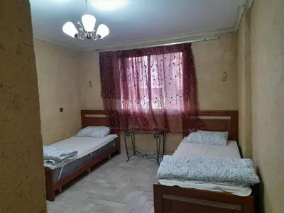 two beds in a room with a window at Village al baraka in Oulad Akkou