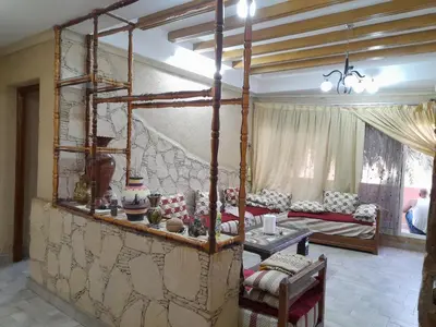 a living room with a large bed in a room at Village al baraka in Oulad Akkou