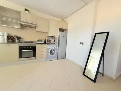 a kitchen with a refrigerator and a mirror in it at Marina Asilah golf, tennis pool in Oulad Akkou