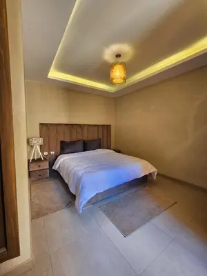 a bedroom with a large bed in a room at Appartement de Pause Intérieure in Oulad Akkou