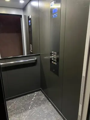 a metal elevator with a door in a building at Appartement de Pause Intérieure in Oulad Akkou
