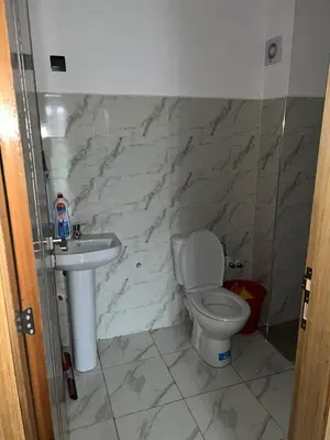 a bathroom with a toilet and a sink at Appartement in Oulad Akkou