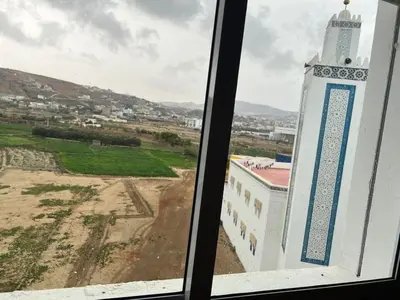 a view of a building from a window at Appartement in Oulad Akkou
