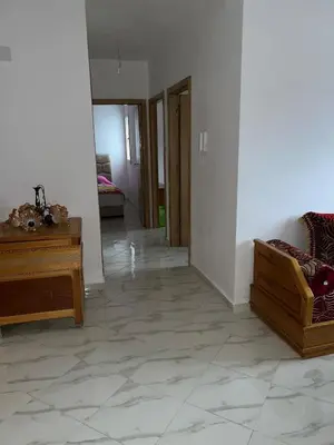 a living room with a couch and a table at Appartement in Oulad Akkou