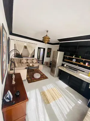 a living room with a couch and a table at Villas Appart Hotel in Oulad Akkou