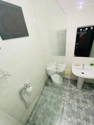 a bathroom with a toilet and a sink at Villas Appart Hotel in Oulad Akkou