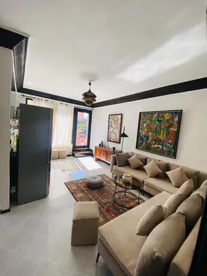 a living room with a couch and a table at Villas Appart Hotel in Oulad Akkou