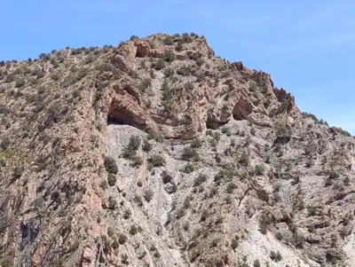 a mountain with an opening in the side of it at Almarkaz Assiyahi