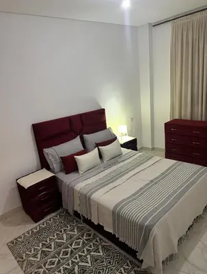 a bedroom with a large bed with two pillows at Appartement a louer meknes in Meknès