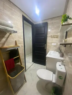 a bathroom with a toilet and a sink at Appartement a louer meknes in Meknès