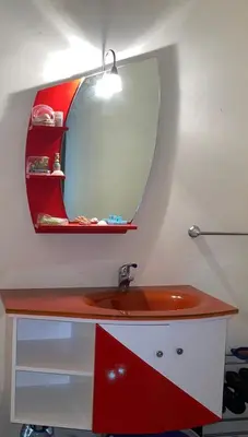 a bathroom with a red sink and a mirror at Saidia in Oulad Akkou