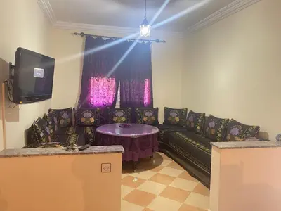 a living room with a couch and a table at Saidia in Oulad Akkou