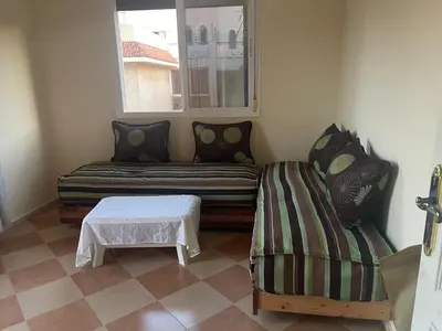 a living room with a couch and a table at Saidia in Oulad Akkou