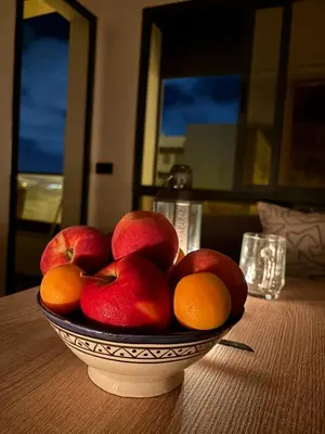 a bowl of apples and oranges on a table at Chambre, appartement Anas in Oulad Akkou