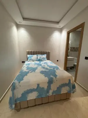 a bedroom with a large bed in a room at Chambre, appartement Anas in Oulad Akkou