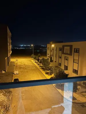 a view of an empty parking lot at night at Chambre, appartement Anas in Oulad Akkou