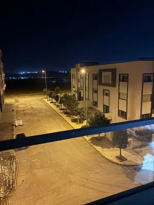 a view from a window of a parking lot at night at Chambre, appartement Anas in Oulad Akkou