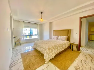 a bedroom with a bed and a large window at Maison Hijaz in Oulad Akkou