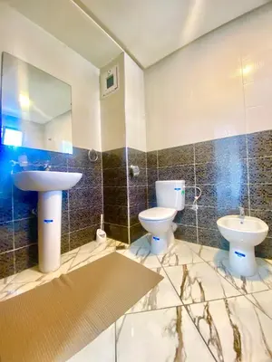 a bathroom with a sink and a toilet and a mirror at Maison Hijaz in Oulad Akkou